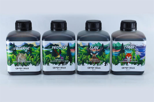 Vier Flaschen des Crazy Hills Explorer Packs mit biologischen Düngemitteln für Pflanzenwachstum und Blüte, mit Wald- und Wildtiergrafiken auf den Etiketten.